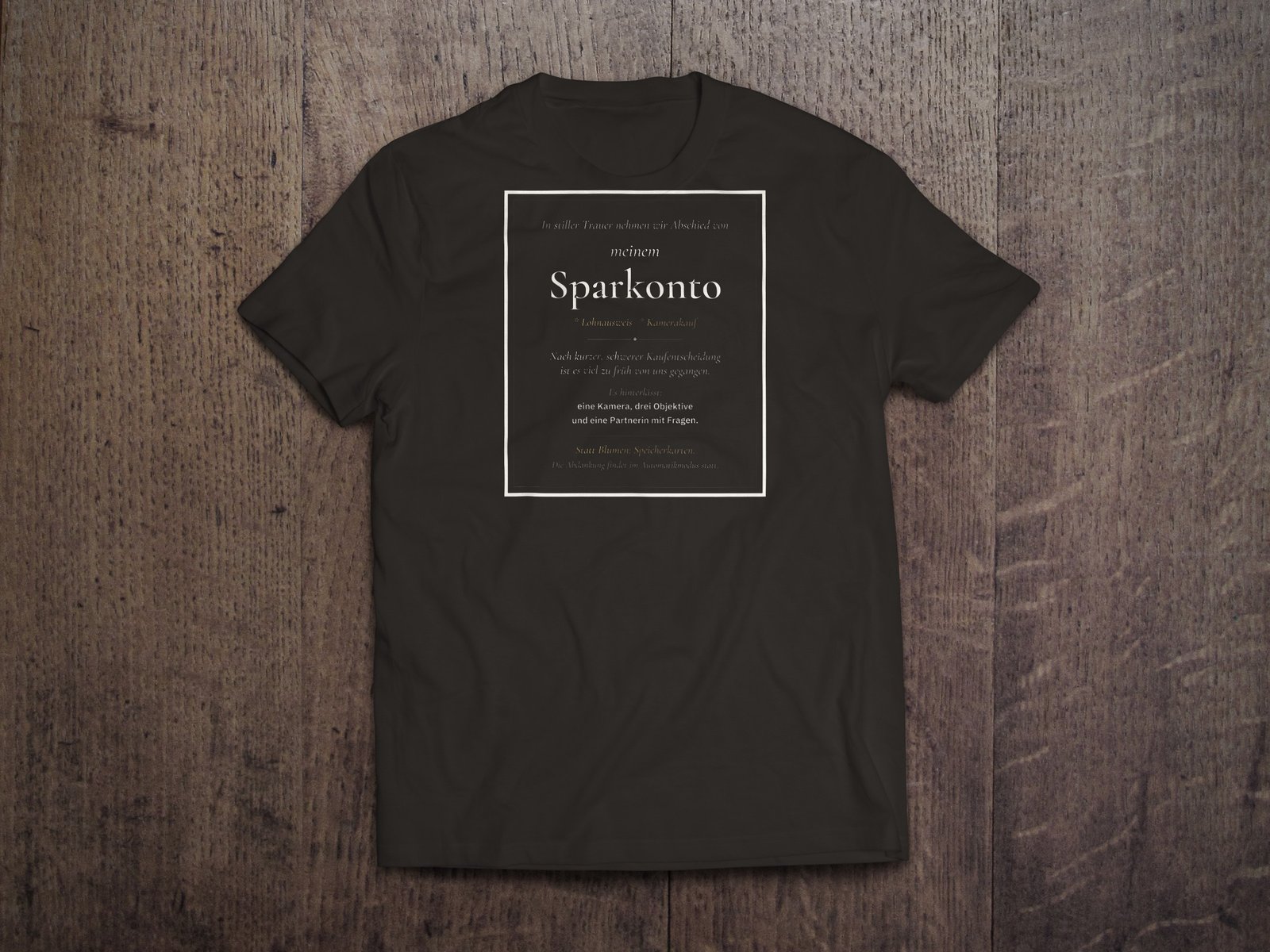 Edles Fotografen-T-Shirt «Traueranzeige Sparkonto» von hemmi.photo – Brustdruck auf Deep Black